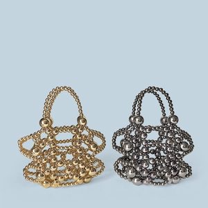 Detail of handcrafted beaded handbags in metallic gold and black with woven texture