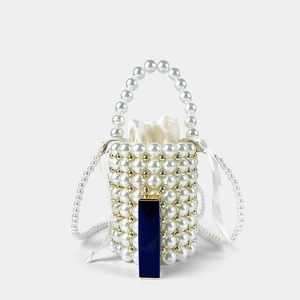 Detail of handmade pearl bucket bag with gold beads and cream satin drawstring liner