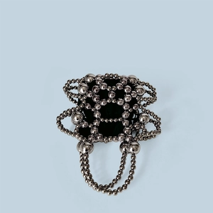 Detailed top view of silver beaded handbag with metallic finish and black fabric lining