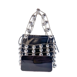 Mini metal cage handbag with silver beaded structure, black inner pouch and phone for scale