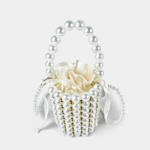 Detailed close-up of handmade pearl bucket bag with satin drawstring lining and large handles