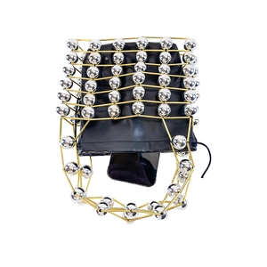 Detailed top view of gold metal cage handbag with silver beads and black drawstring bag
