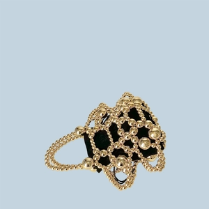 Close-up of golden beaded woven evening bag with black drawstring velvet pouch
