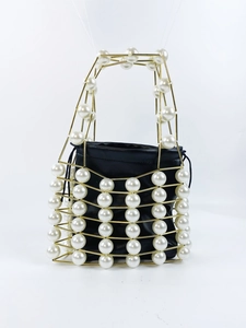 Exquisite pearl hollow metal frame handbag with black drawstring pouch in French retro style