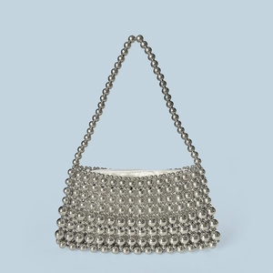 Detail view of handmade silver beaded tote bag with metallic luster and white satin lining