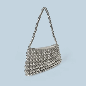 Detail of silver metallic beaded handbag with high-gloss texture and braided handle