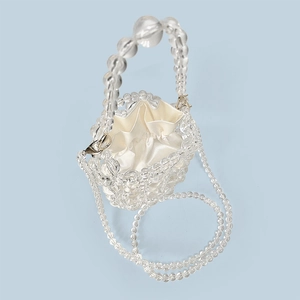 Detail view of handmade clear acrylic beaded bag with cream satin drawstring liner