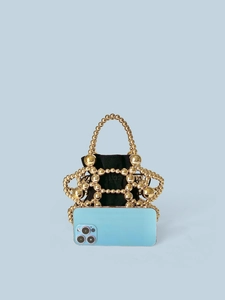 Sparkly gold beaded handbag with black drawstring pouch and smartphone for size reference