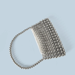 Detail of silver beaded shoulder bag with metallic mirror-finish beads and zipper closure