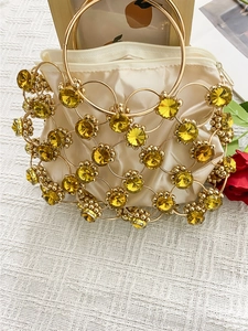 Elegant gold metal ring handbag with yellow crystals and satin lining for evening