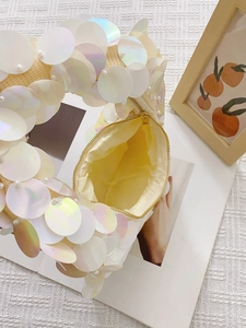 Chic handmade beige sequin handbag with pearl accents shown at a stylish 45-degree angle