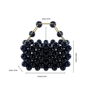 Detail view of 15x10cm handmade beaded handbag with black beads and gold hardware