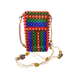 Detailed view of colorful beaded phone bag with woven shoulder strap and metal lobster clasp