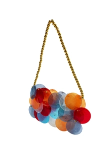Detail of colorful acrylic paillette evening bag with gold beaded top handle
