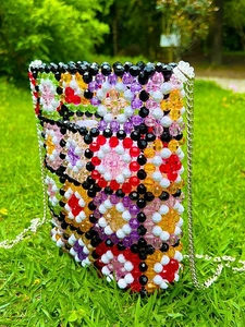 Colorful handmade beaded crossbody bag with floral patterns and silver chain strap