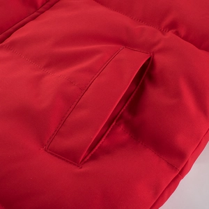 Children's red winter jacket featuring quilted fabric and functional side pocket design