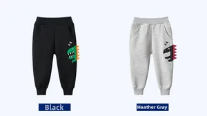 Detail of kids joggers showing 3D dinosaur spikes and printed graphics on the leg