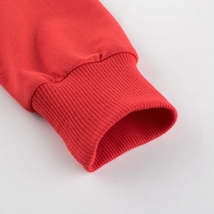 Close-up of red cotton sweatshirt ribbed cuffs with high-quality stitching detail