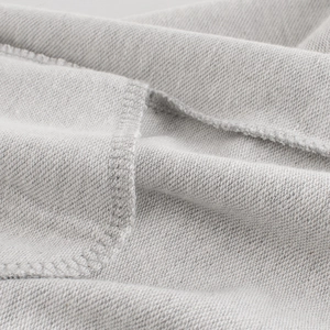 Gros plan du pantalon de sport gris pour garçon montrant la texture et les coutures du tissu