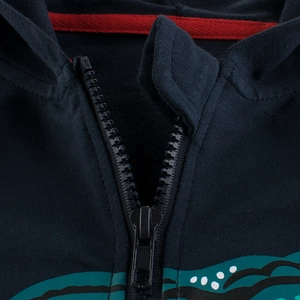 Navy blue kids zip-up hoodie featuring contrast red neck tape and green wave print detail