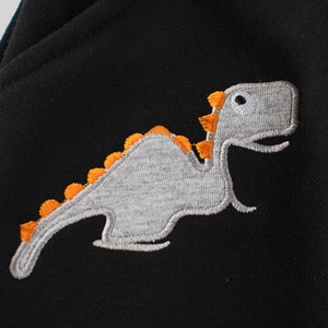 Kids black jogger pants with detailed grey dinosaur embroidery and orange spikes