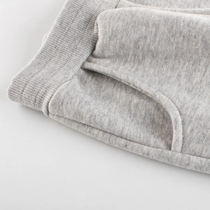 Grey knit joggers for children featuring an elastic ribbed waistband and side pockets