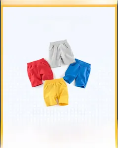 Flat lay of colorful cotton boy shorts in grey, red, blue, and yellow with elastic waist