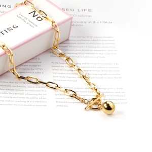Detail view of 18K gold plated paperclip chain necklace with OT toggle clasp and gold ball