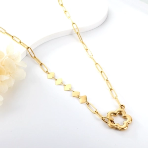 Detailed macro view of 18K gold plated paperclip chain with heart pendant and flower charm