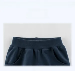 Detail of navy blue kids knit shorts showing ribbed elastic waistband and side pockets