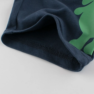 Close-up of deep blue cotton shorts for boys featuring durable double-stitch seams and green print
