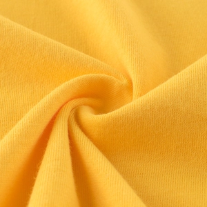 Close-up of ginger yellow knitted cotton fabric showing soft texture for kids vest