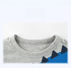 Close-up of the ribbed crew neck and soft knit texture of this grey dinosaur t-shirt