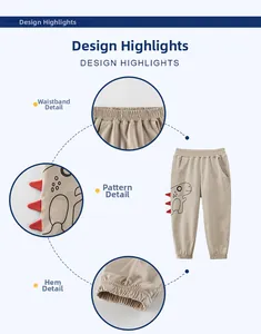Detail view of khaki boys joggers with elastic waist and dinosaur design with 3D accents