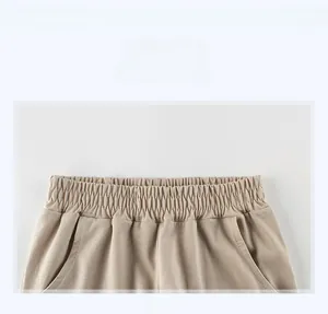 Detail of elastic waistband and side pockets on boys' khaki summer sports trousers