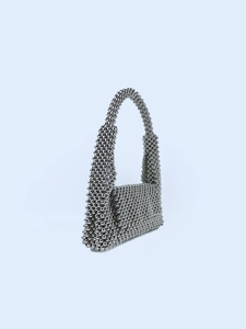 Close-up of shiny silver metallic beaded handbag with handcrafted trapezoid design