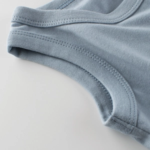 Close-up of boys blue sleeveless vest showing premium knit fabric and neat stitching