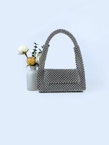 Close-up of silver beaded handbag with mirror finish plating and elegant beadwork