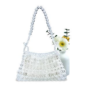 Detail of handmade clear beaded bag with white satin drawstring liner and woven strap