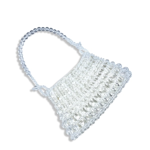 Detailed close-up of handmade clear beaded handbag with transparent acrylic beads