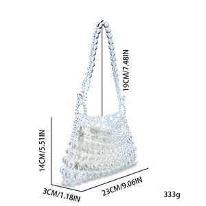 Detail view of transparent beaded handbag with white inner pouch and 19cm handle
