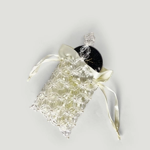Close-up of beaded flower bag with satin drawstring liner for cosmetics