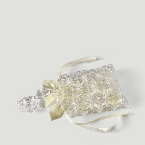 Detailed close-up of handmade acrylic flower beads with elegant satin drawstring pouch