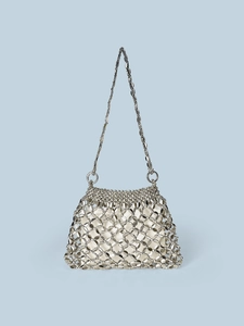 Detailed close-up of metallic silver disc chainmail handbag with satin inner drawstring bag