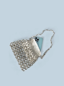 Detailed top view of a silver sequin woven bag showing metal mesh and satin lining