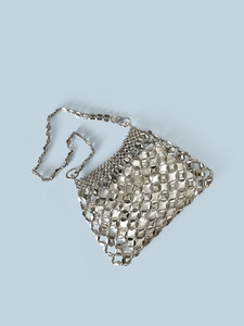 Detail of silver metallic disc sequins on the shoulder bag with sleek chain strap