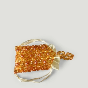 Detailed amber acrylic flower beadwork with soft satin drawstring lining and handle
