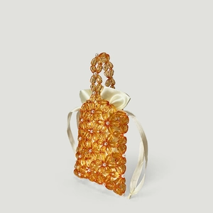 Detail of amber acrylic flower beads with pearls and satin drawstring inner bag