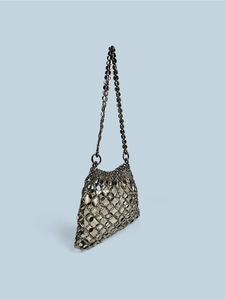 Detail of gunmetal sequins on woven shoulder bag with satin lining and hollow grid
