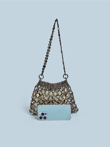 Detail of silver metallic beaded handbag with gold satin lining and smartphone for size